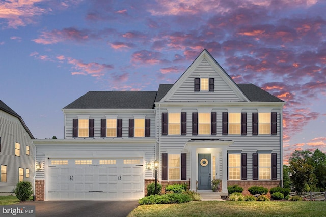 15634 Calum Ct, Haymarket, VA 20169 - view of front of home with brick siding, asphalt driveway, and an attached garage