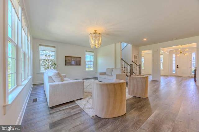 15634 Calum Ct, Haymarket, VA 20169 - living room featuring a chandelier, baseboards, stairs, and wood finished floors