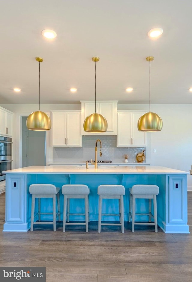 15634 Calum Ct, Haymarket, VA 20169 - kitchen with stainless steel double oven, white cabinets, decorative backsplash, and recessed lighting