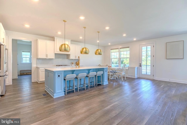 15634 Calum Ct, Haymarket, VA 20169 - kitchen with freestanding refrigerator, a kitchen island with sink, white cabinets, dark wood-style floors, and recessed lighting