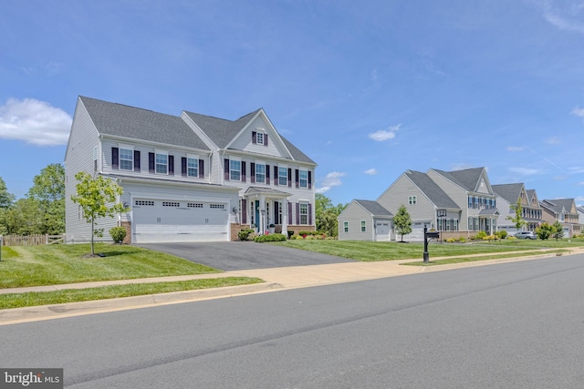 15634 Calum Ct, Haymarket, VA 20169 - townhome / multi-family property with asphalt driveway, an attached garage, a front yard, and a residential view