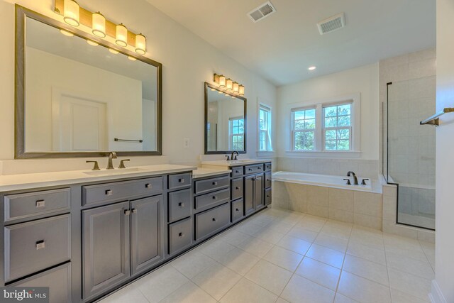15634 Calum Ct, Haymarket, VA 20169 - full bathroom with double vanity, a bath, tile patterned floors, tiled shower, and recessed lighting