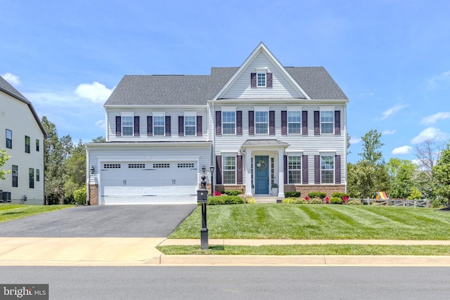 15634 Calum Ct, Haymarket, VA 20169 - view of front of home featuring driveway, a front yard, an attached garage, central AC, and brick siding