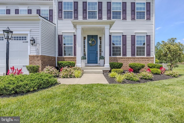 15634 Calum Ct, Haymarket, VA 20169 - entrance to property featuring brick siding, a lawn, and an attached garage