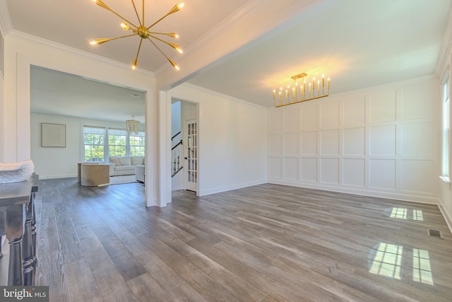 15634 Calum Ct, Haymarket, VA 20169 - unfurnished living room featuring a chandelier, wood finished floors, ornamental molding, and baseboards