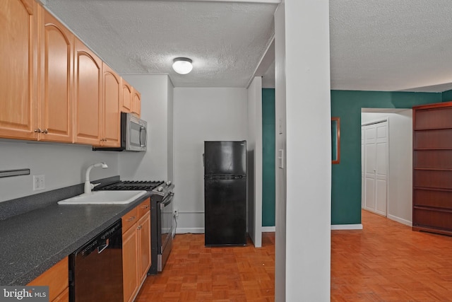 1801 Clydesdale Pl NW Unit 420, Washington, DC 20009 - kitchen featuring black appliances, a textured ceiling, a sink, dark countertops, and baseboards