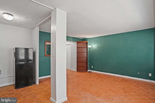 1801 Clydesdale Pl NW Unit 420, Washington, DC 20009 - unfurnished living room featuring a textured ceiling and baseboards
