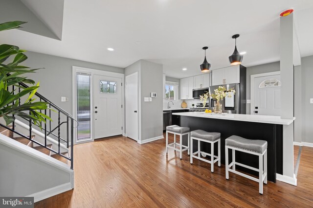 3408 Croydon Rd, Gwynn Oak, MD 21207 - foyer entrance with baseboards, wood finished floors, stairway, and recessed lighting