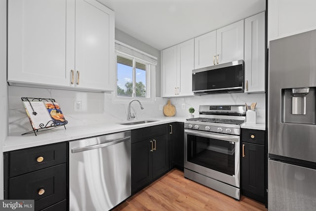 3408 Croydon Rd, Gwynn Oak, MD 21207 - kitchen with appliances with stainless steel finishes, a sink, dark cabinets, and white cabinetry