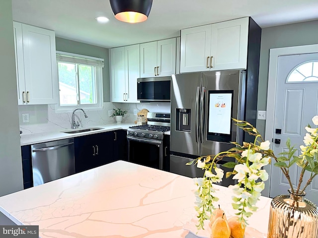 3408 Croydon Rd, Gwynn Oak, MD 21207 - kitchen featuring stainless steel appliances, a sink, light stone countertops, and white cabinetry