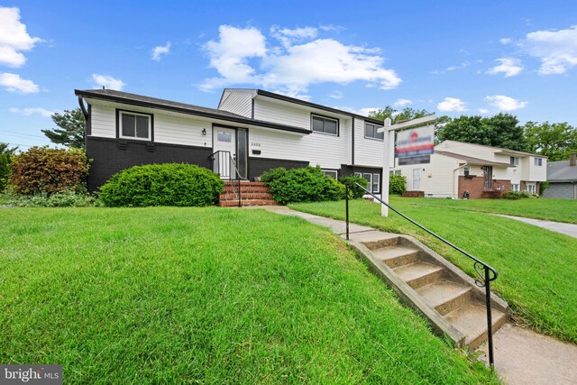 3408 Croydon Rd, Gwynn Oak, MD 21207 - tri-level home featuring a front lawn and brick siding