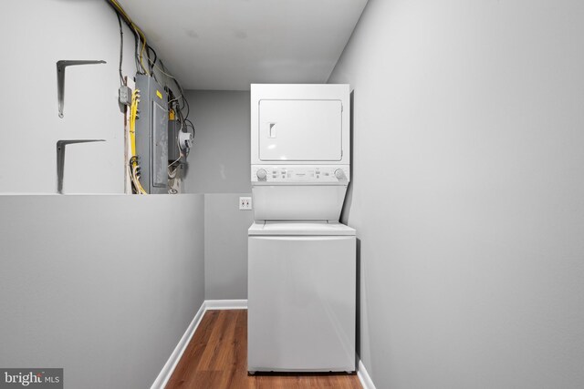3408 Croydon Rd, Gwynn Oak, MD 21207 - laundry area with estacked washer and dryer, wood finished floors, baseboards, and electric panel