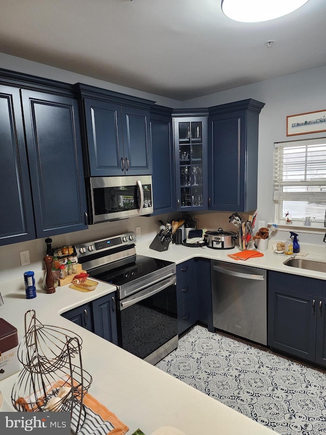 37484 Pettinaro Dr Unit 8300, Ocean View, DE 19970 - kitchen featuring appliances with stainless steel finishes, a sink, blue cabinets, and light countertops