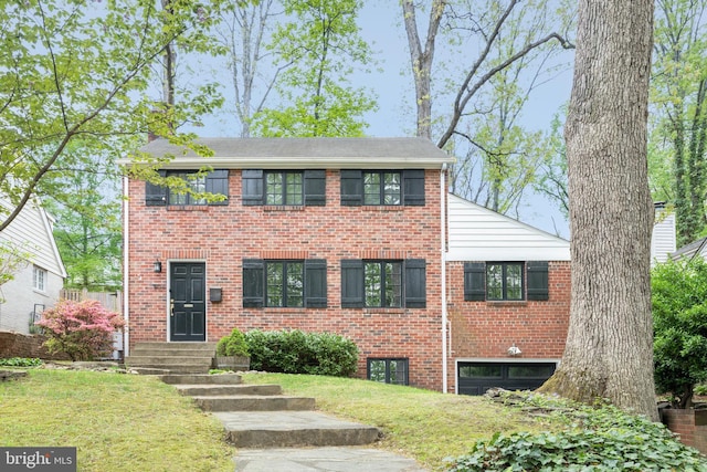 504 Kentucky Ave, Alexandria, VA 22305 - view of front of house with brick siding, a front lawn, and a chimney