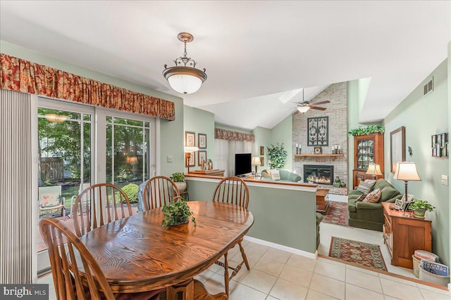 614 Timber Wood Blvd, Newark, DE 19702 - dining room with a fireplace, ceiling fan, light tile patterned floors, and vaulted ceiling