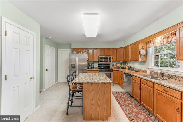 614 Timber Wood Blvd, Newark, DE 19702 - kitchen with appliances with stainless steel finishes, a sink, a center island, a kitchen breakfast bar, and light stone countertops