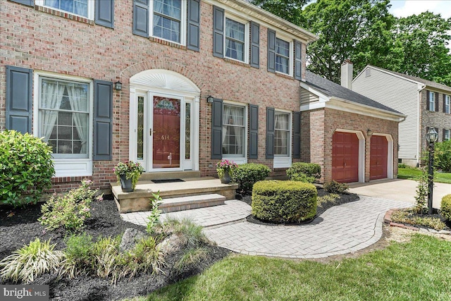 614 Timber Wood Blvd, Newark, DE 19702 - view of front of property featuring a garage, brick siding, and concrete driveway