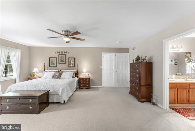 614 Timber Wood Blvd, Newark, DE 19702 - bedroom with light carpet, a sink, ensuite bath, and baseboards