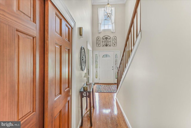 614 Timber Wood Blvd, Newark, DE 19702 - entrance foyer with stairs, light wood-type flooring, ornamental molding, baseboards, and a chandelier