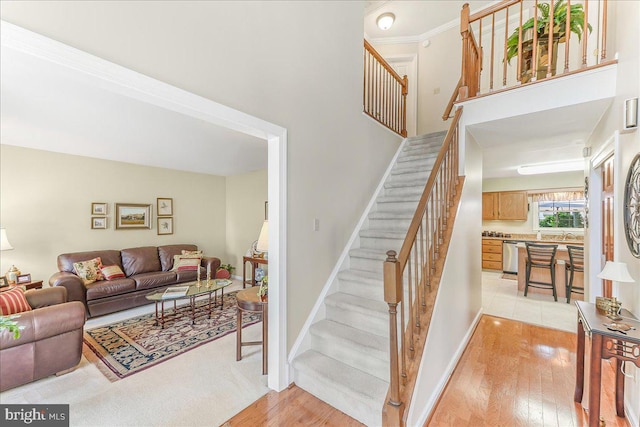 614 Timber Wood Blvd, Newark, DE 19702 - stairs featuring hardwood / wood-style flooring, baseboards, and a high ceiling