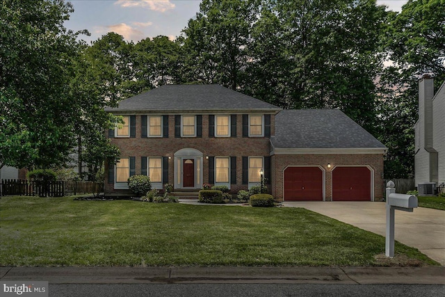 614 Timber Wood Blvd, Newark, DE 19702 - colonial home with brick siding, a garage, concrete driveway, central AC, and roof with shingles