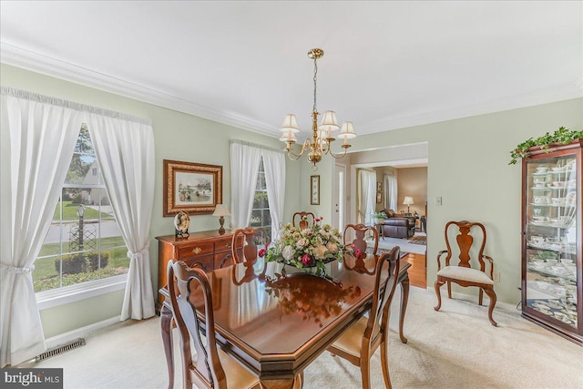 614 Timber Wood Blvd, Newark, DE 19702 - dining space with light colored carpet, a chandelier, ornamental molding, and baseboards