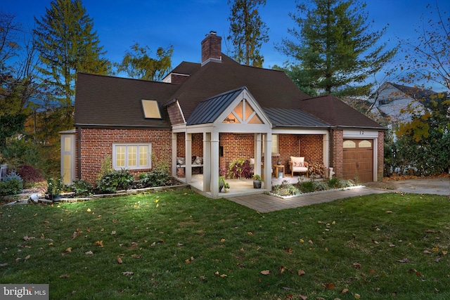 12 Chestnut Ln, Wayne, PA 19087 - rear view of property featuring brick siding, a yard, a garage, and a chimney