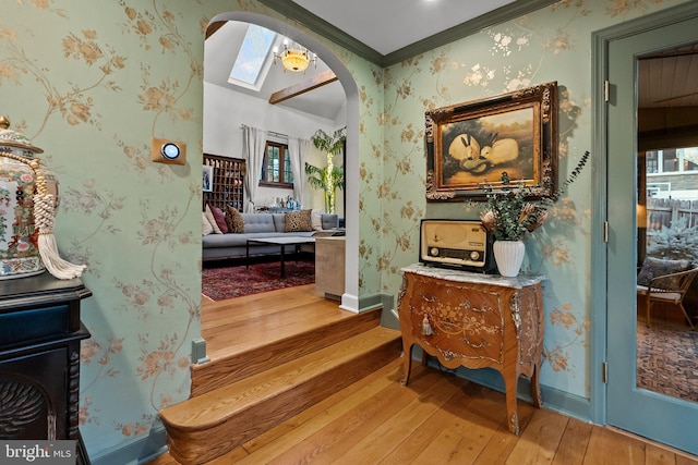 12 Chestnut Ln, Wayne, PA 19087 - corridor with arched walkways, hardwood / wood-style floors, wallpapered walls, baseboards, and crown molding