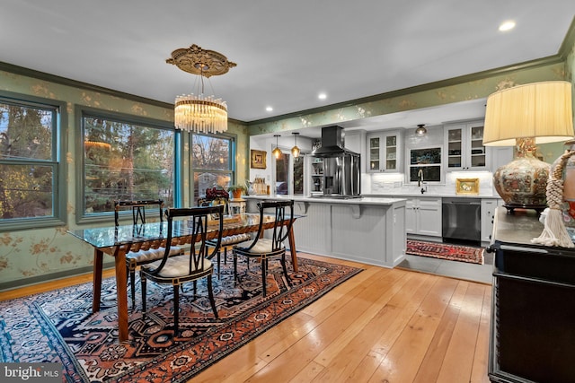 12 Chestnut Ln, Wayne, PA 19087 - dining area with crown molding, light wood-style flooring, a chandelier, and wallpapered walls