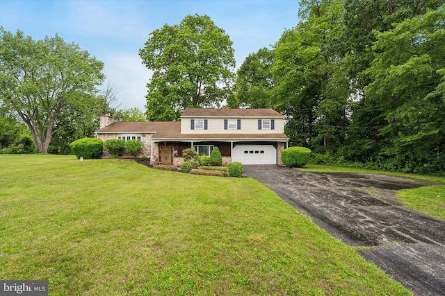 711 Pikeland Ave, Spring City, PA 19475 - view of front of home with asphalt driveway, a garage, a front yard, a chimney, and stone siding
