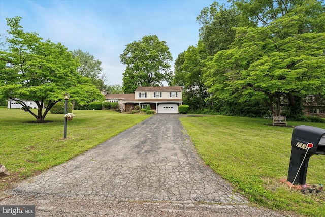 711 Pikeland Ave, Spring City, PA 19475 - view of front facade featuring asphalt driveway, a front lawn, and a garage