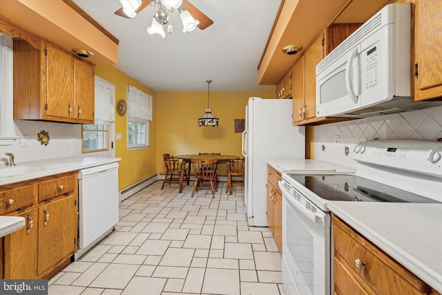 711 Pikeland Ave, Spring City, PA 19475 - kitchen with white appliances, a sink, backsplash, and brown cabinetry