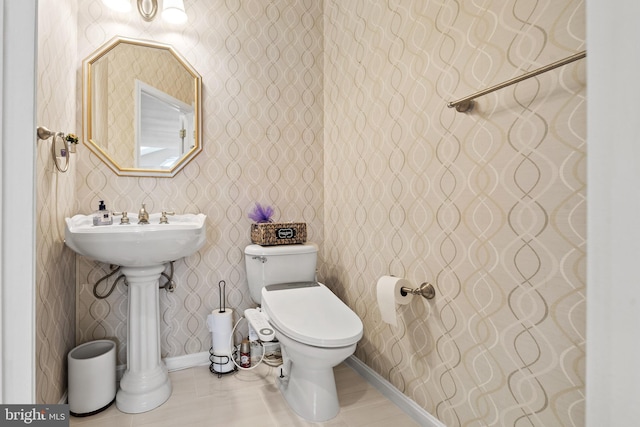 10000 Umbrella Pl, Nokesville, VA 20181 - half bathroom with tile patterned flooring, toilet, wallpapered walls, and baseboards