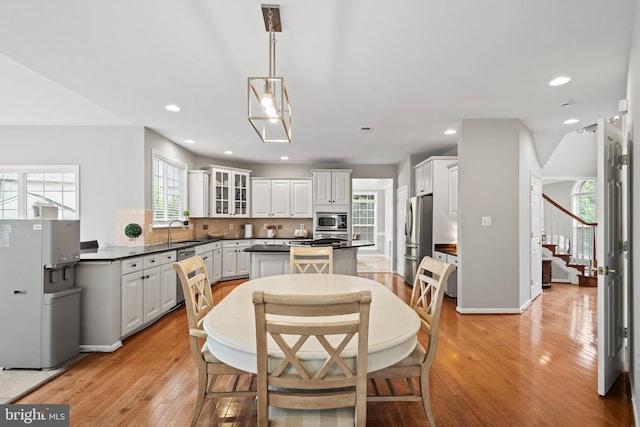 10000 Umbrella Pl, Nokesville, VA 20181 - dining room featuring light wood-style floors, stairway, and recessed lighting