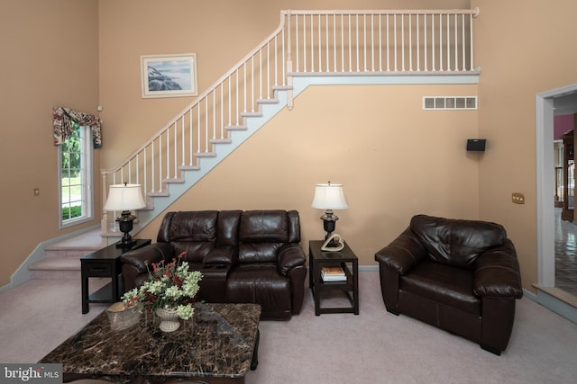 1224 Highland Dr, Orefield, PA 18069 - carpeted living area featuring a towering ceiling, stairs, and baseboards
