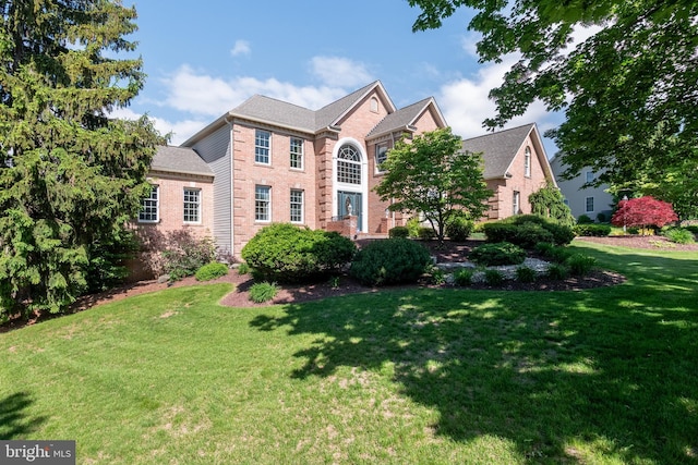 1224 Highland Dr, Orefield, PA 18069 - colonial-style house featuring brick siding and a front yard