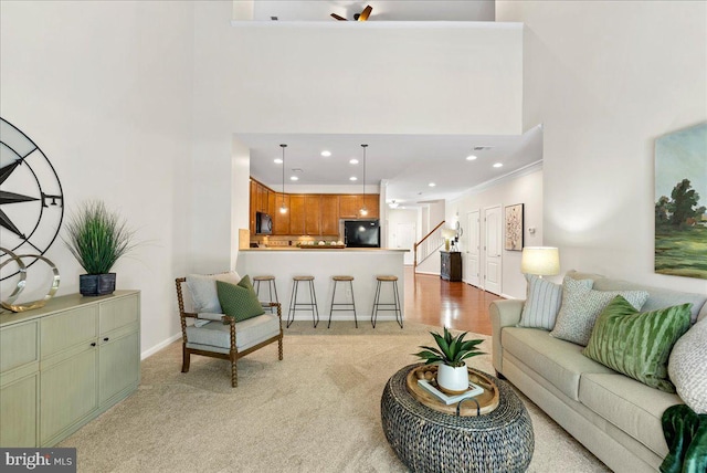 44324 Stableford Sq, Ashburn, VA 20147 - living room with stairway, light carpet, baseboards, recessed lighting, and a high ceiling