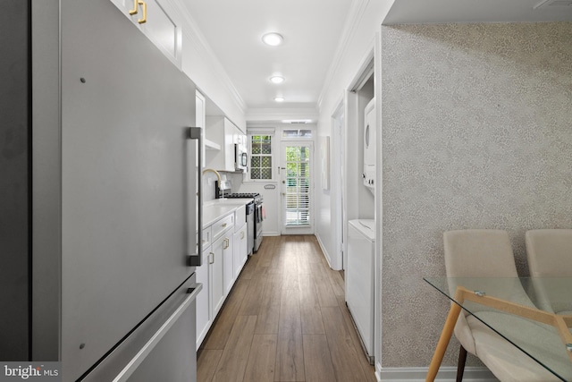 3 Russell Rd Unit 3B, Alexandria, VA 22301 - kitchen with appliances with stainless steel finishes, ornamental molding, white cabinets, recessed lighting, and wood finished floors