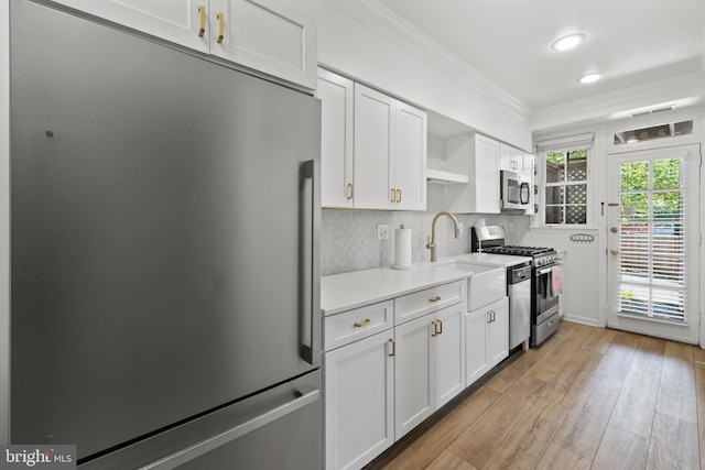 3 Russell Rd Unit 3B, Alexandria, VA 22301 - kitchen featuring stainless steel appliances, open shelves, crown molding, white cabinets, and light wood-style flooring