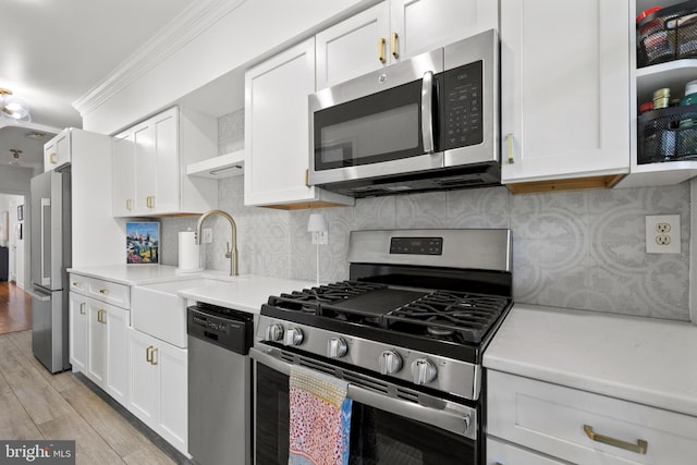 3 Russell Rd Unit 3B, Alexandria, VA 22301 - kitchen with appliances with stainless steel finishes, light countertops, white cabinets, and crown molding