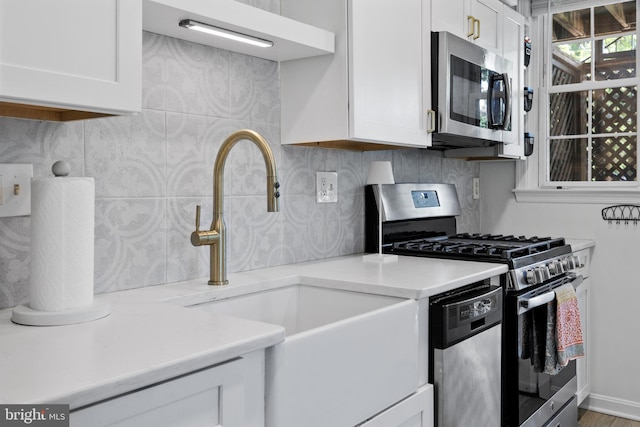 3 Russell Rd Unit 3B, Alexandria, VA 22301 - kitchen featuring stainless steel appliances, white cabinetry, and decorative backsplash