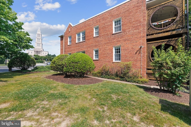 3 Russell Rd Unit 3B, Alexandria, VA 22301 - view of property exterior featuring a yard and brick siding