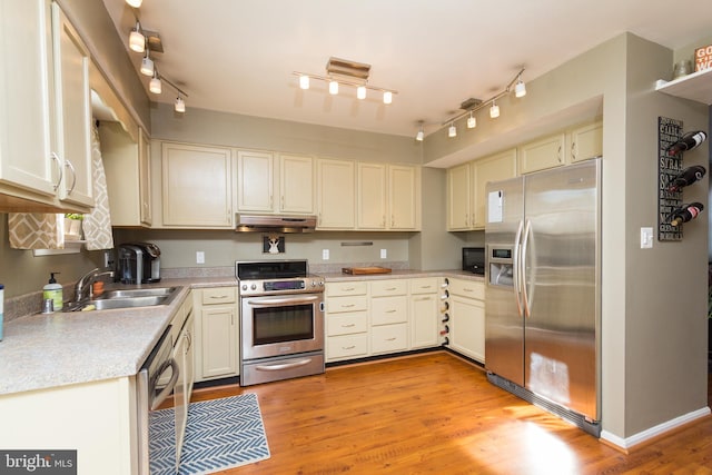 41 Luffing Ct, Baltimore, MD 21221 - kitchen with stainless steel appliances, track lighting, under cabinet range hood, and a sink