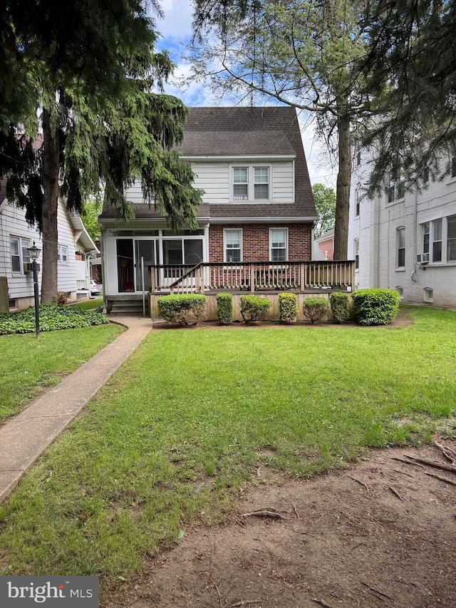 827 Pennsylvania Ave, York, PA 17404 - view of front of property with brick siding, a front lawn, and roof with shingles