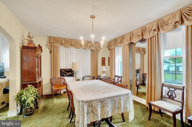 827 Pennsylvania Ave, York, PA 17404 - dining room featuring a chandelier, dark carpet, healthy amount of natural light, and baseboards
