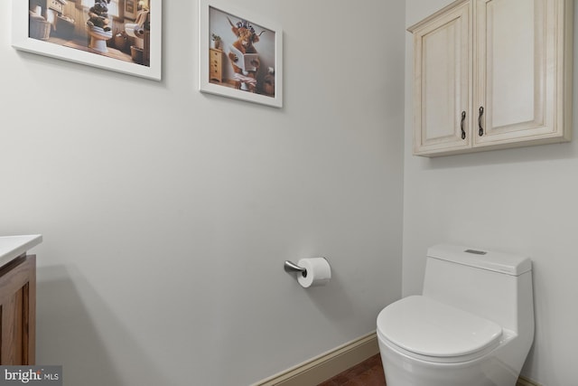 6133 Jennifer Ln, Spring Grove, PA 17362 - bathroom featuring vanity, toilet, baseboards, and wood finished floors