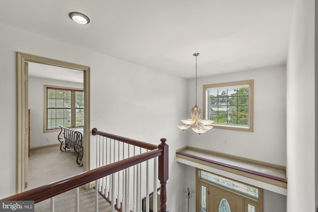 6133 Jennifer Ln, Spring Grove, PA 17362 - hallway featuring a chandelier, plenty of natural light, an upstairs landing, and carpet flooring
