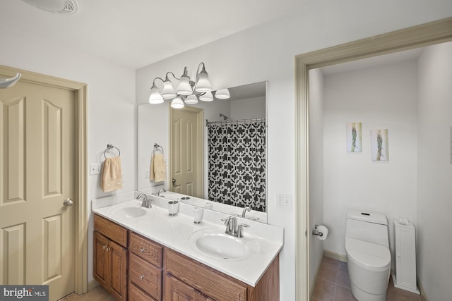6133 Jennifer Ln, Spring Grove, PA 17362 - full bathroom featuring toilet, double vanity, and tile patterned floors