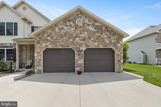 6133 Jennifer Ln, Spring Grove, PA 17362 - view of front of house with stone siding, concrete driveway, an attached garage, and a front yard