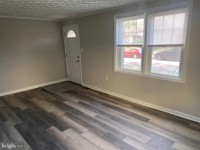 1311 Sycamore Ave, Wilmington, DE 19805 - entryway featuring baseboards, healthy amount of natural light, crown molding, and wood finished floors